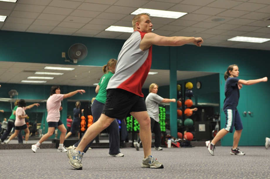 a group of people exercising in the gym